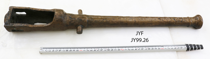 Large breech-loaded copper alloy cannon measuring over 4 feet long. Wide end of cannon is open for loading shot.